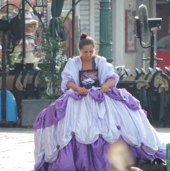 In the record breaking heat last August this girl dressed in her finery to entertain tourists along the waterfront.